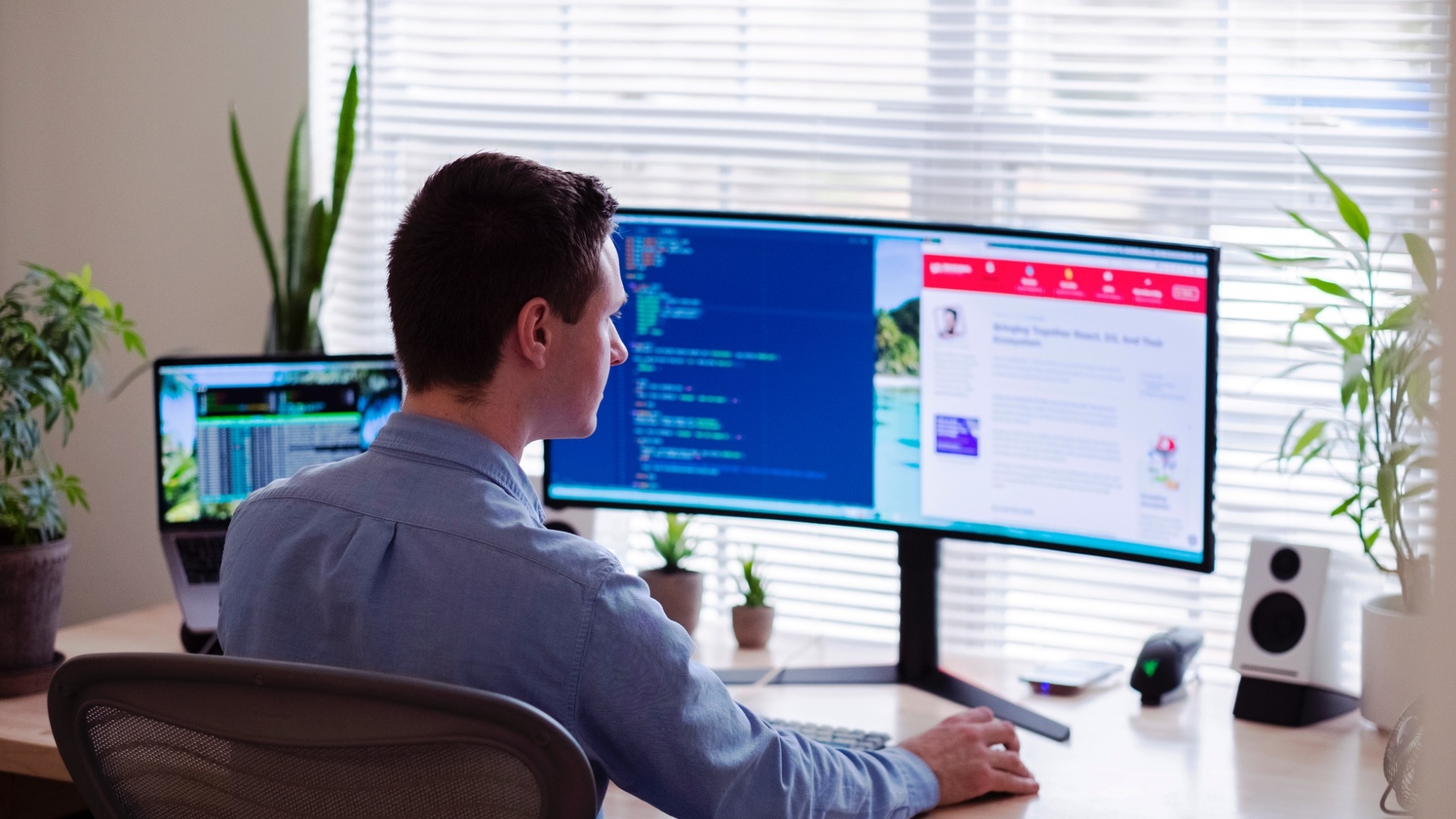 Man working in front of two computer monitors