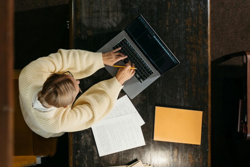 A person using a laptop at a desk