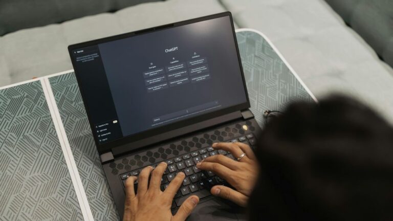 A person has ChatGPT open on a laptop and is writing a prompt on it.