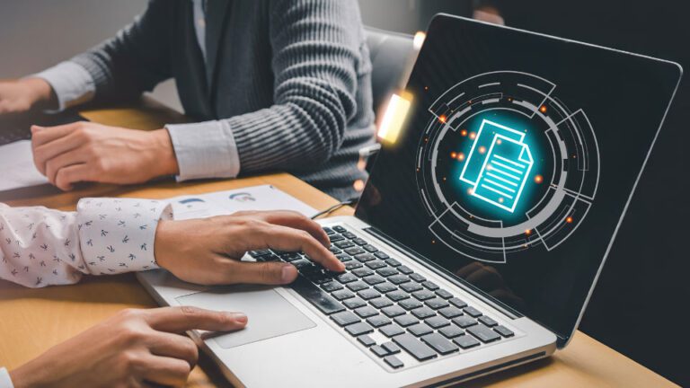 A person working on a laptop with a digital document icon.